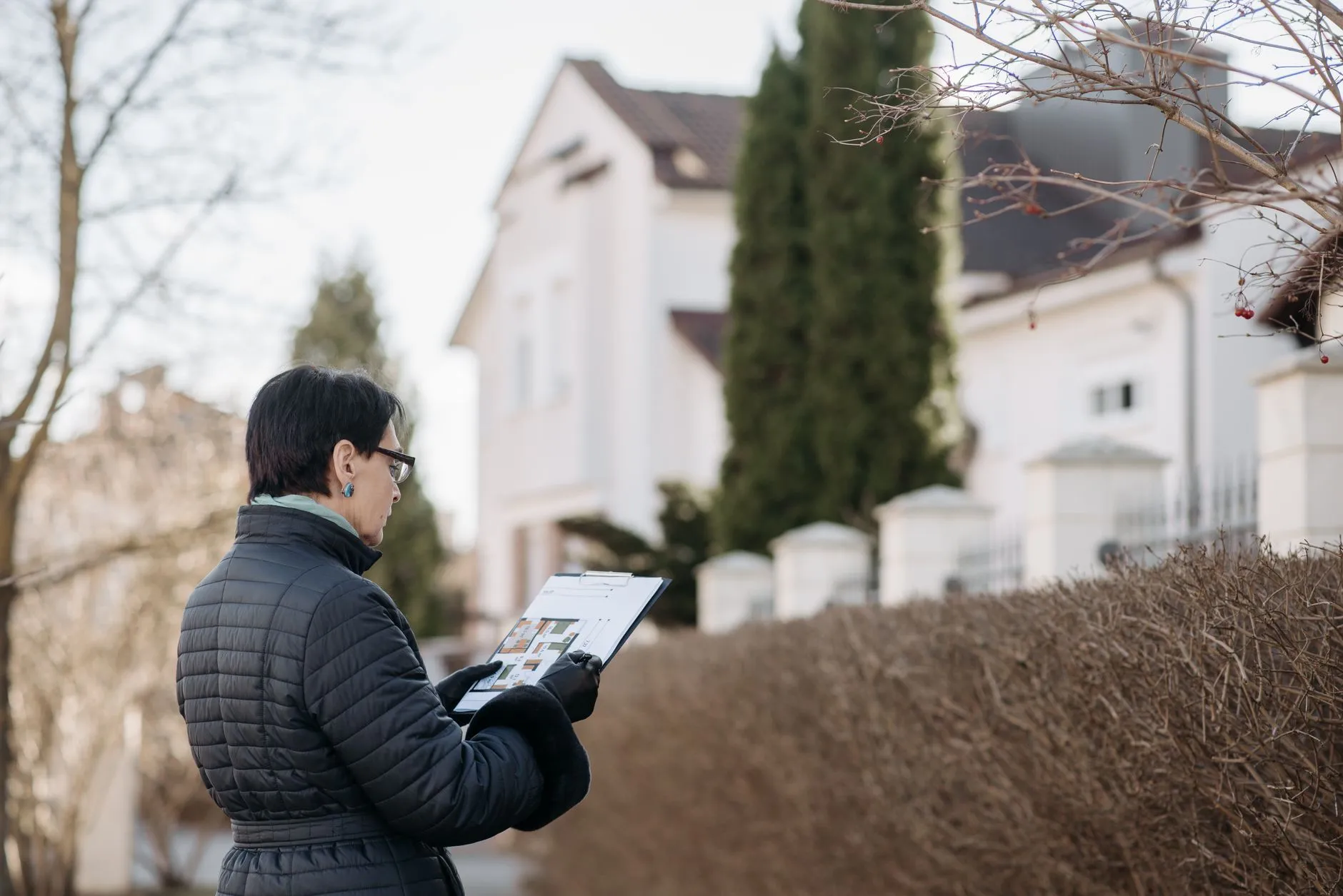 A technician inspecting a wall in a French house.