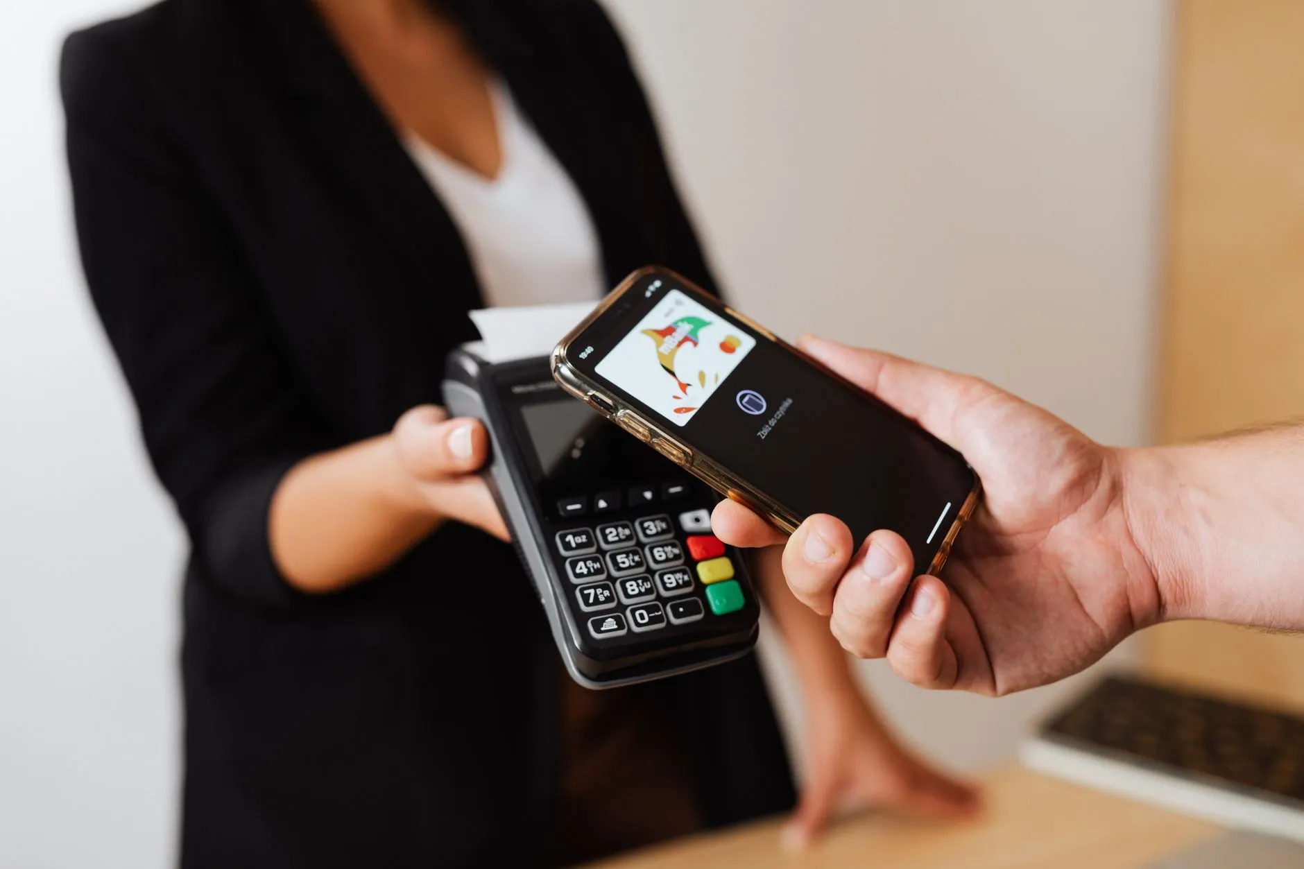 Hands holding a smartphone to make an online payment for notary services.